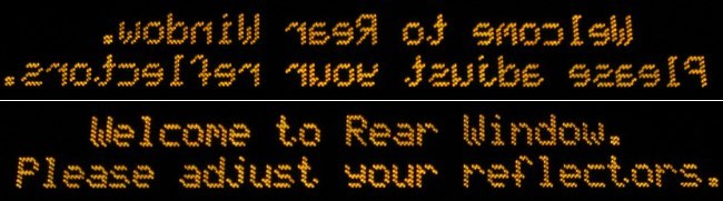 ‘Welcome to Rear Window. Please adjust your reflectors’ placeholder message in amber LED type