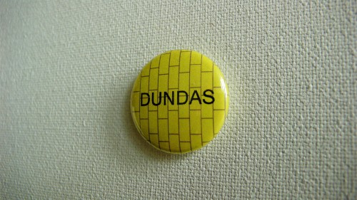 Yellow button reads DUNDAS against illustration of chartreuse tiles