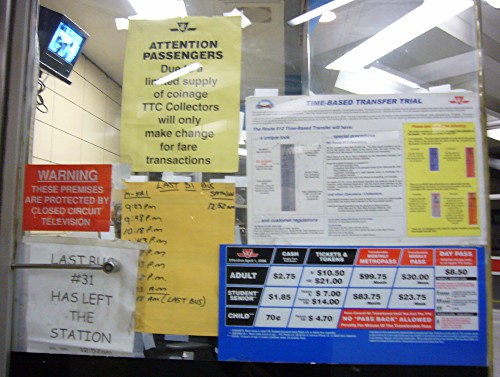 Window has four official preprinted signs, a handwritten one, and a sign reading LAST BUS #31 HAS LEFT THE STATION printed in Comic Sans