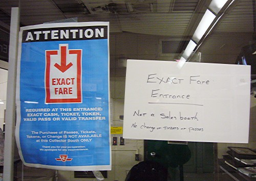 Preprinted and handwritten signs explain that this is an automated entrance