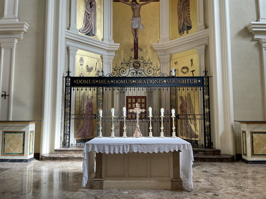 Raised metal letters in Times caps above sanctuary