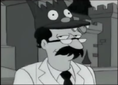 Bespectacled man with mouse-head cap